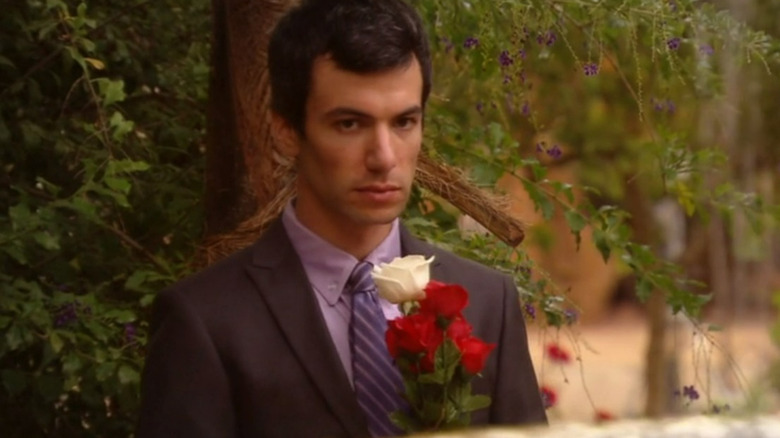 Nathan Fielder holding flower bouquet