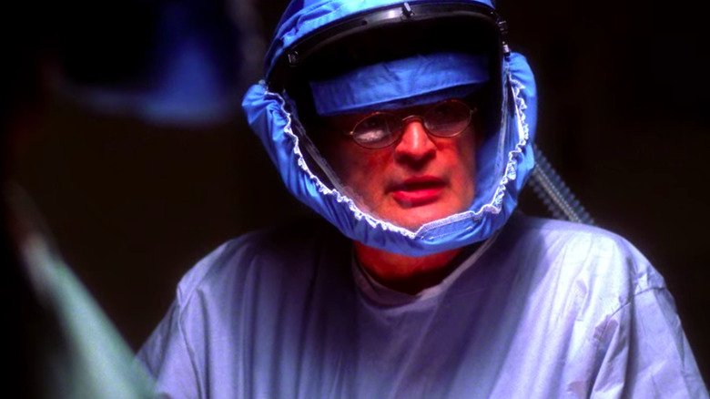 David McCallum in hazmat suit