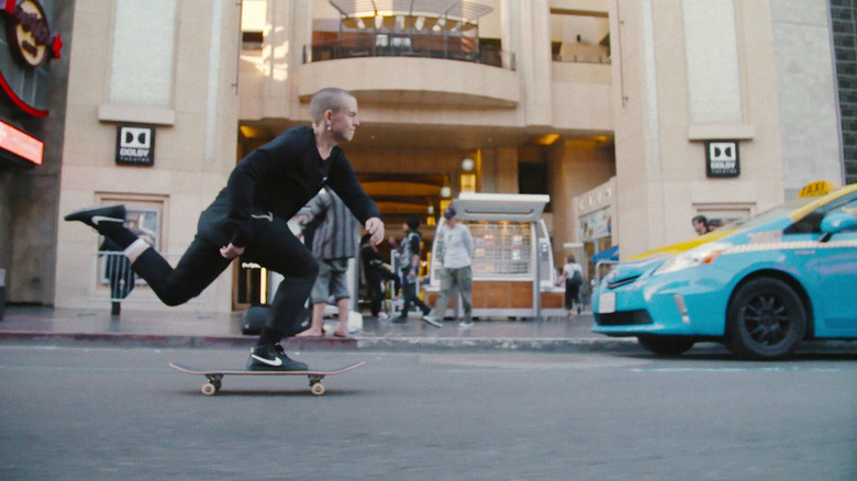 Leo Baker skateboarding down a New York City street