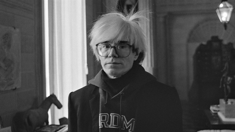 Andy Warhol standing in a museum