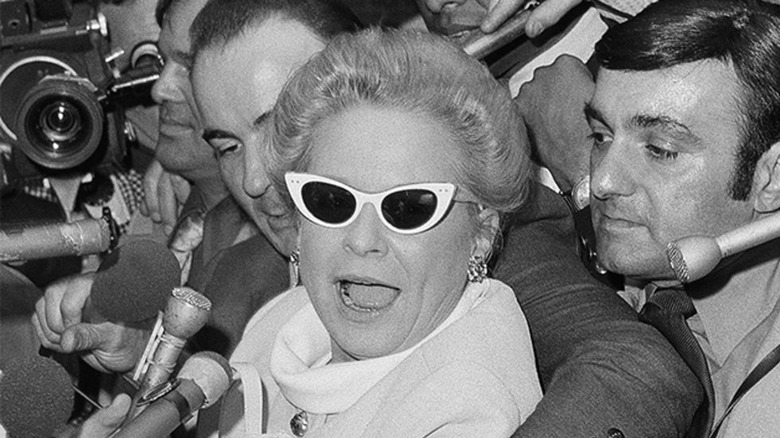 Martha Mitchell being hounded by performers outside the White House