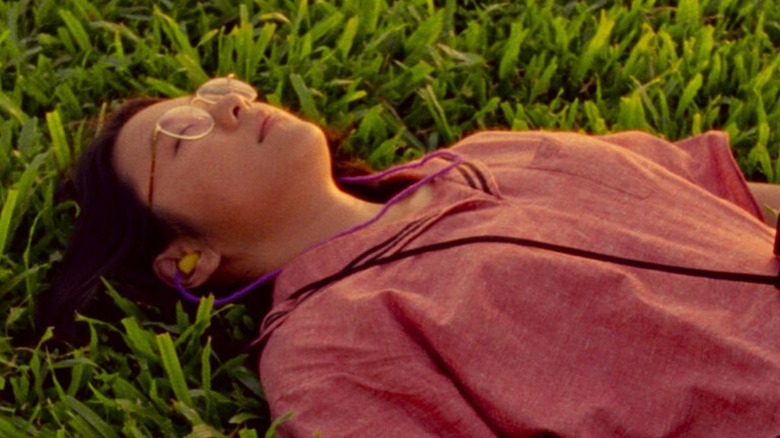 Sandi Tan lying in grass