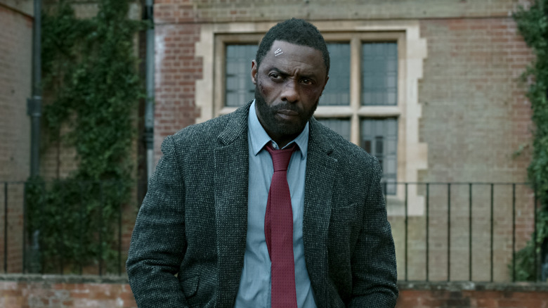 Luther standing wearing suit