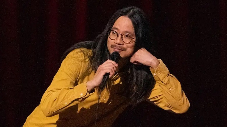 Sheng Wang leans to one side during the performance of his stand-up special Sweet and Juicy