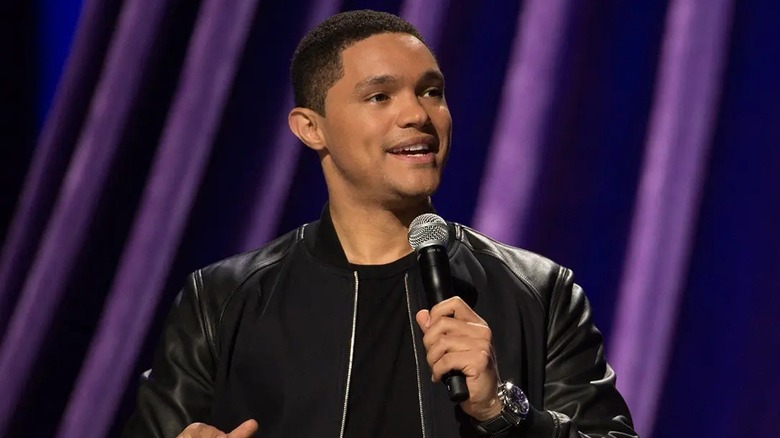 Trevor Noah onstage performing his stand-up special Afraid of the Dark