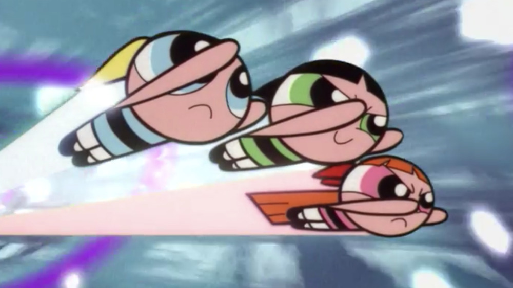 The Powerpuff Girls speed through a wormhole created by their own extreme speed.