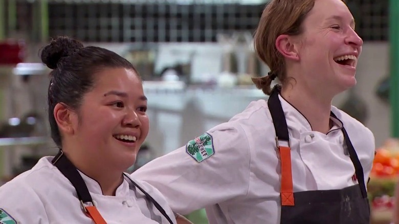 Top Chef contestants laughing in kitchen