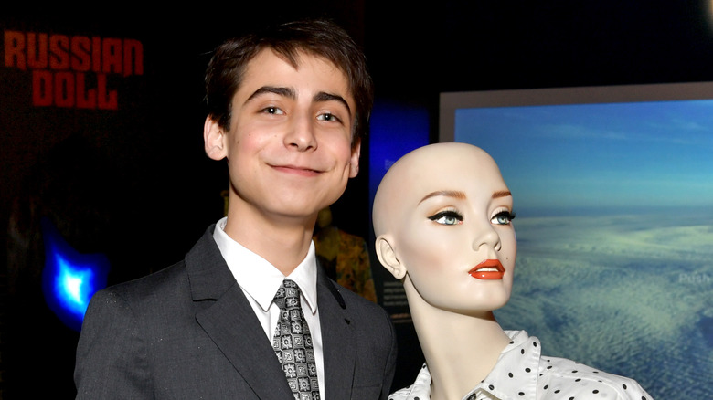 Aidan Gallagher holding Dolores