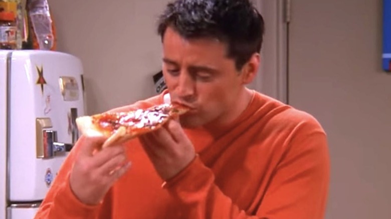 Joey eats pizza on Friends