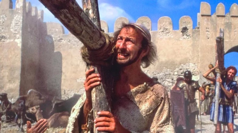 Brian carries a cross