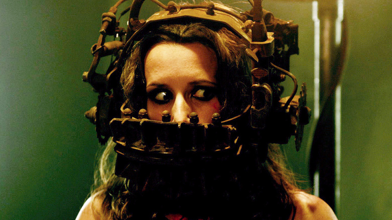 A woman about to play a game in the original Saw