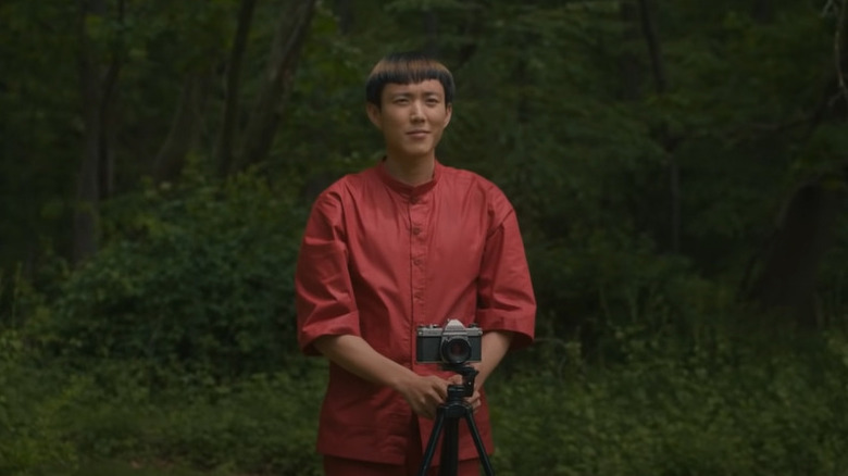 Yang taking photo in woods