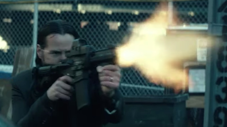 Keanu Reeves firing assault rifle