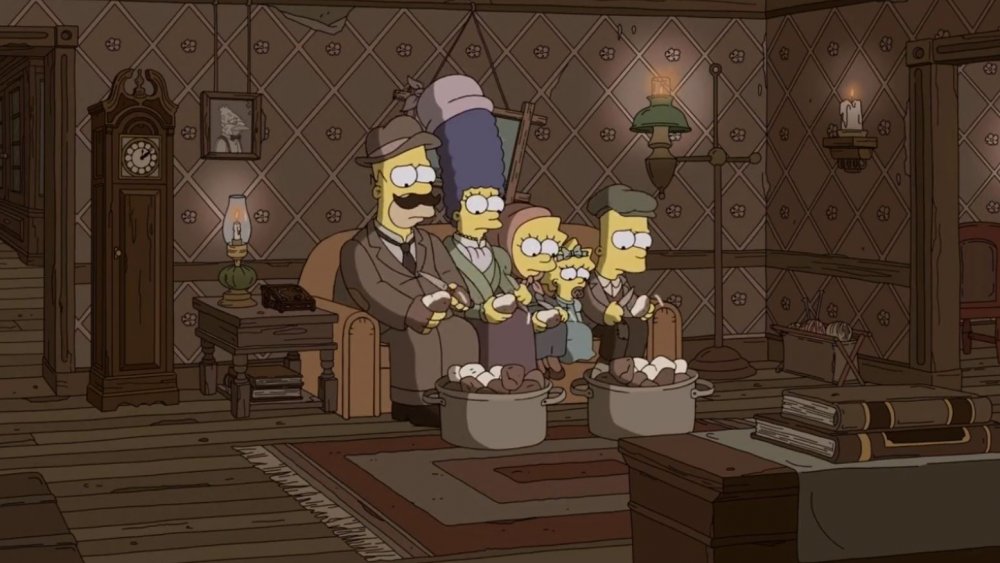 The Simpsons sitting on their couch in the past, from The Simpsons