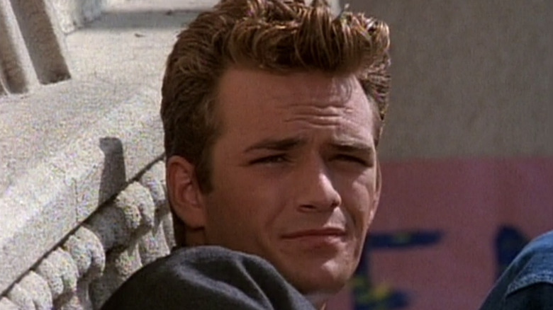 Dylan McKay sitting on steps