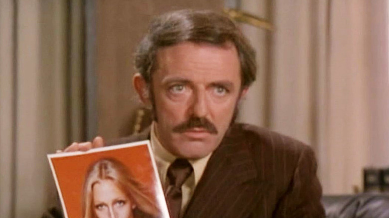 John Astin holds up photo