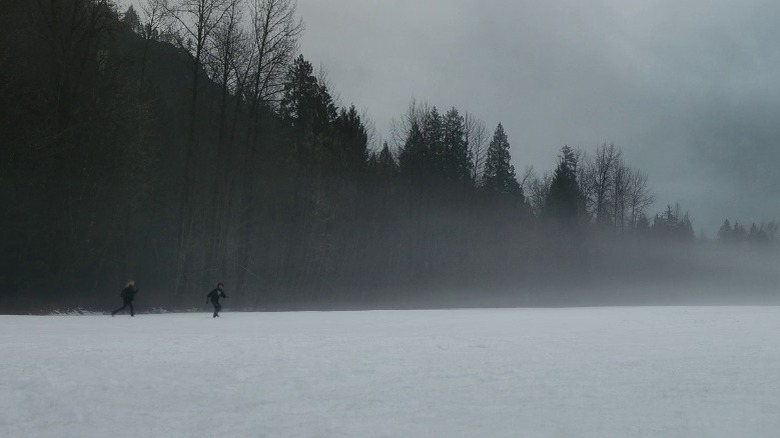 Natalie Scatorccio and Javi Martinez running through a frozen lake