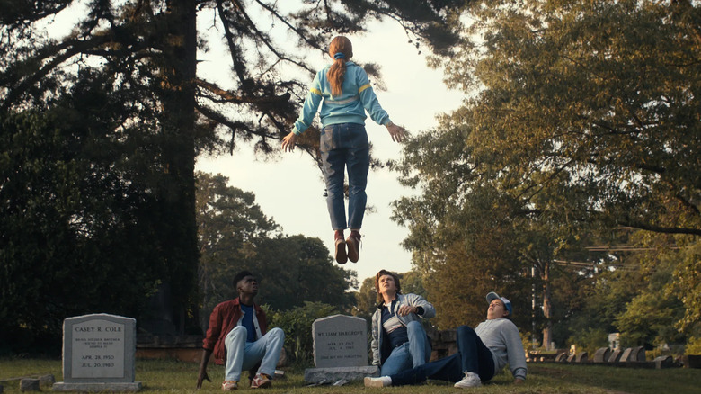 Max levitating above Lucas, Steve, and Dustin in "Stranger Things 4"