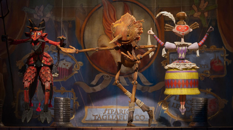 Pinocchio performing on-stage with marionettes 