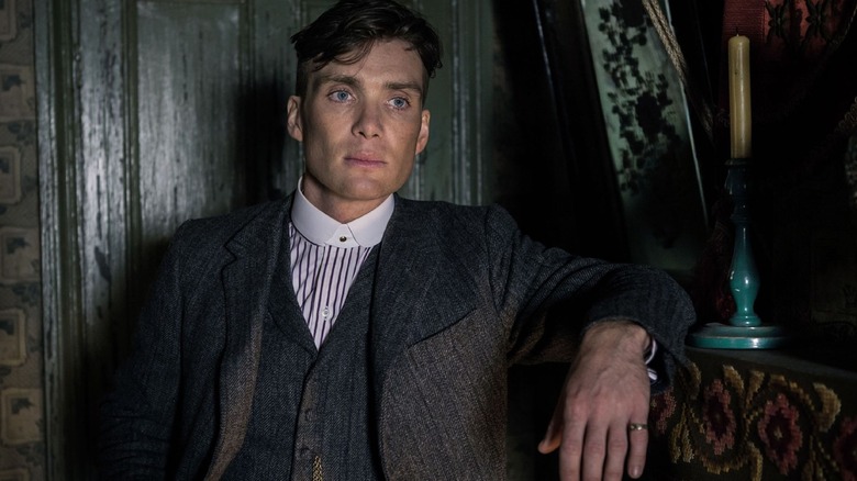 Cillian Murphy leaning on shelf