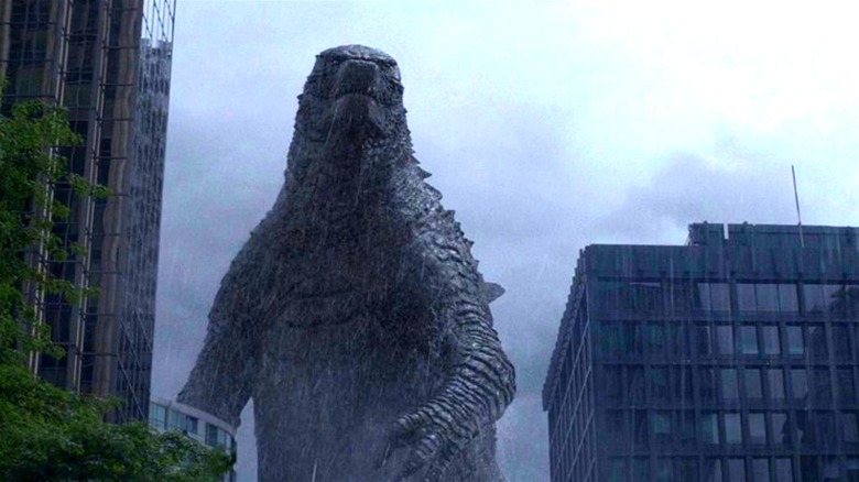 Godzilla standing amid buildings