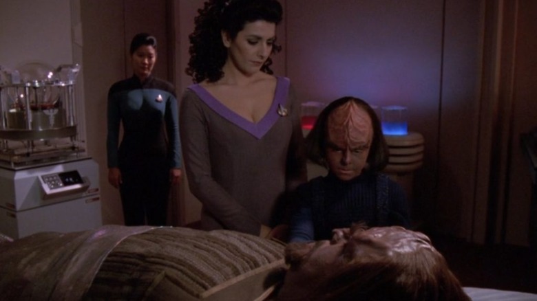 Troi and Alexander beside Worf