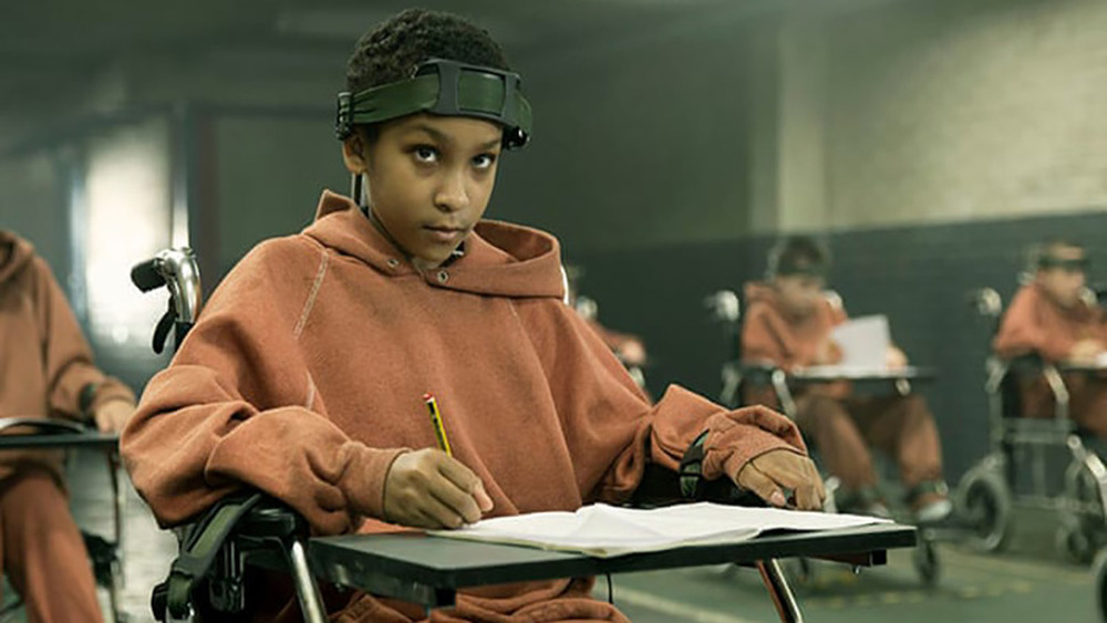 Girl with headpiece looking up from desk