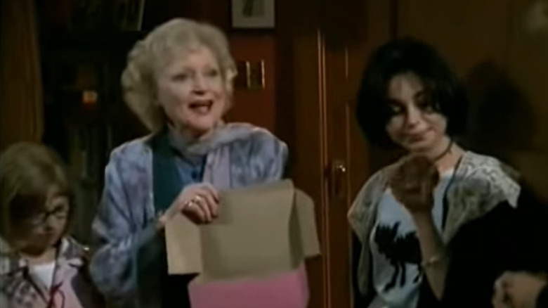 Betty White holding box