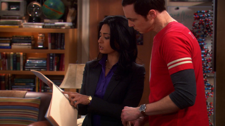 Priya and Sheldon looking at a contract