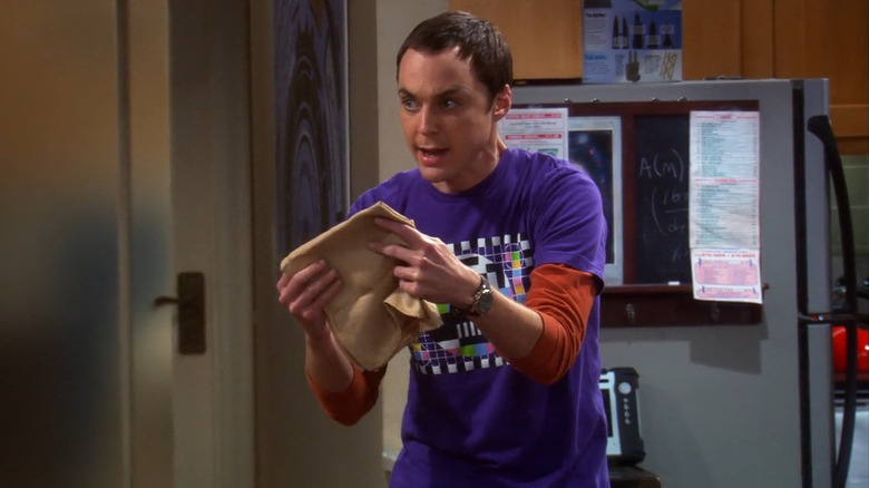 Sheldon excitedly holding a napkin