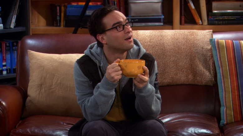 Johnny Galecki holding mug and looking surprised