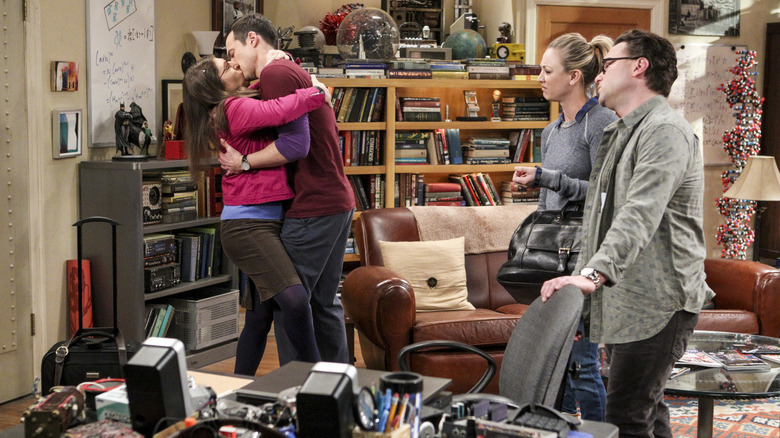 Amy and Sheldon kissing Penny and Leonard staring