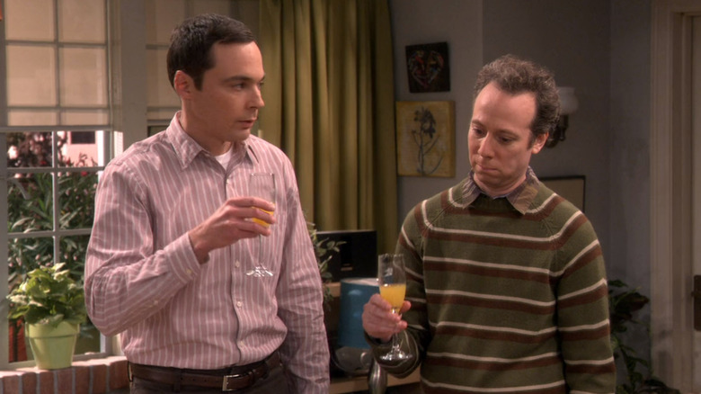 Sheldon and Stuart holding drinks