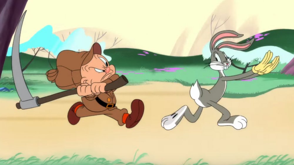 Elmer Fudd chases Bugs Bunny with a scythe on Looney Tunes Cartoons