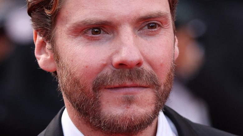 Daniel Brühl looking off camera