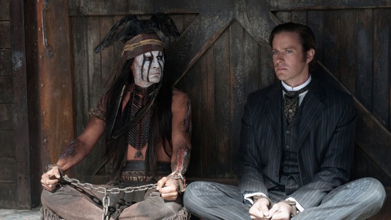 Tonto and the Lone Ranger sitting while shackled (2013)