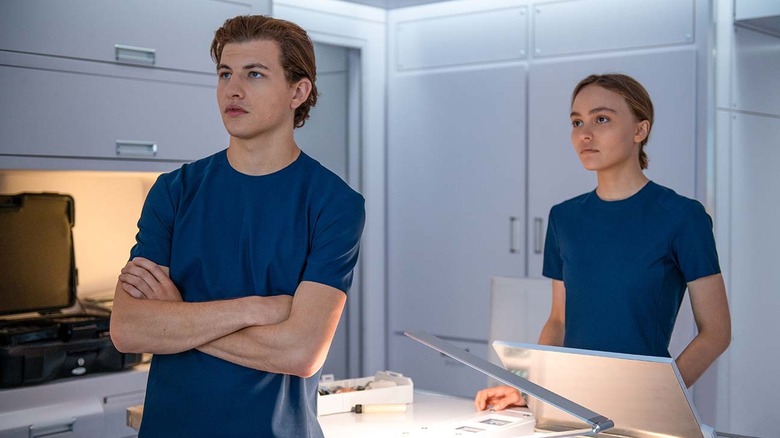 Tye Sheridan and Lily Rose-Depp look over data