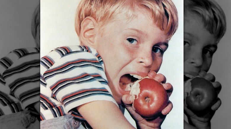 Dennis biting an apple in Dennis the Menace photo