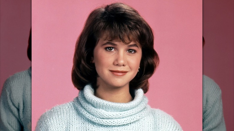 Portrait of Tracey Gold on pink background