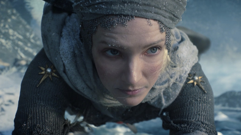 Galadriel scales an icy mountain