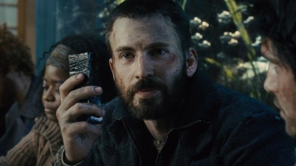 Chris Evans holding up a protein bar in Snowpiercer