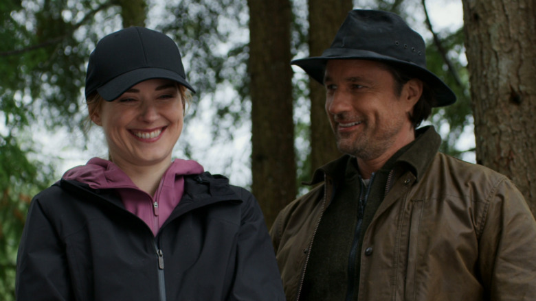 Mel and Jack smiling while in the woods