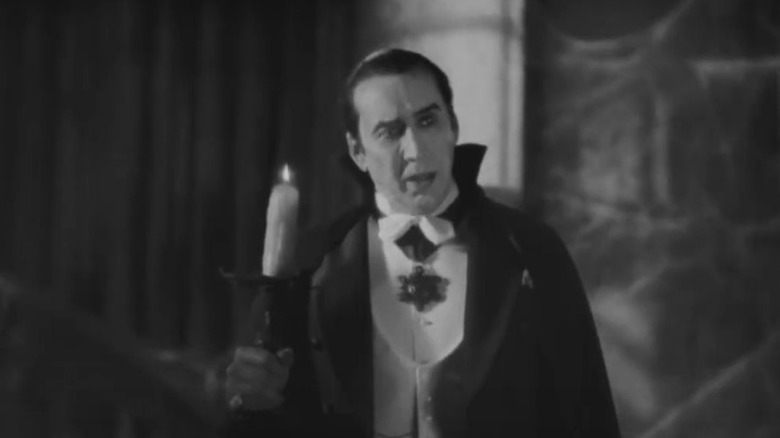 Dracula holds a candle