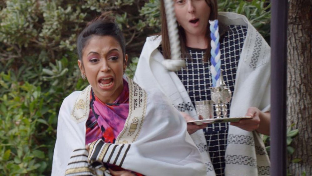 Liza Koshy, draped in a tallit and very confused, on Quibi's Punk'd