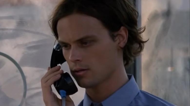 Spencer Reid speaking at a pay phone