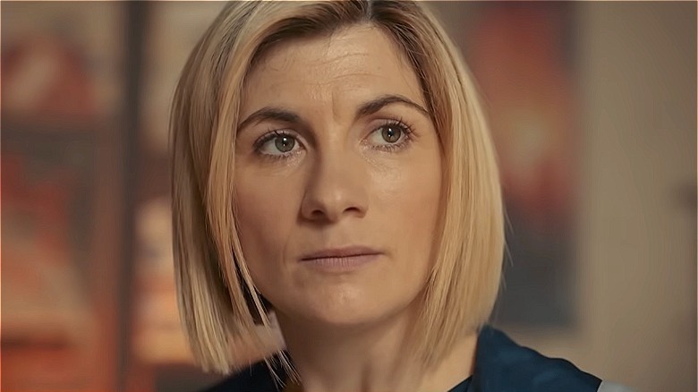 Jodie Whittaker stands as the Doctor