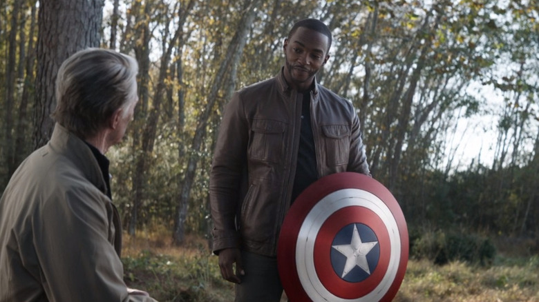 Captain America handing off his shield