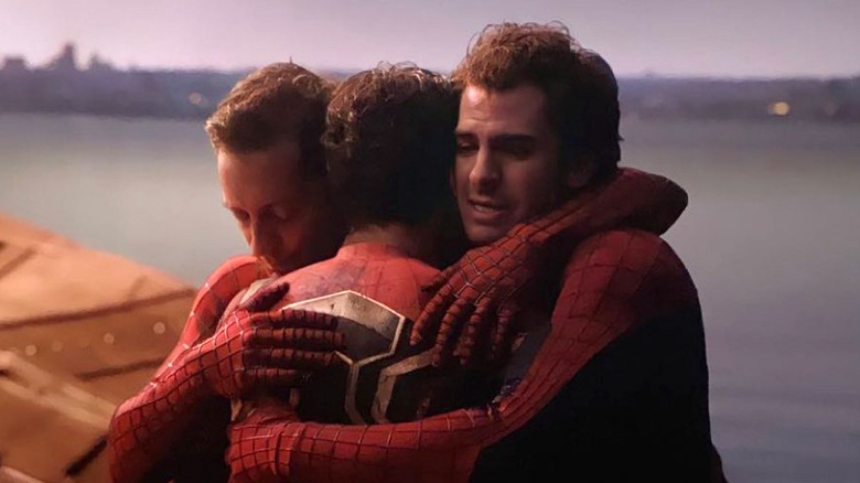 The three Spider-Men hug each other