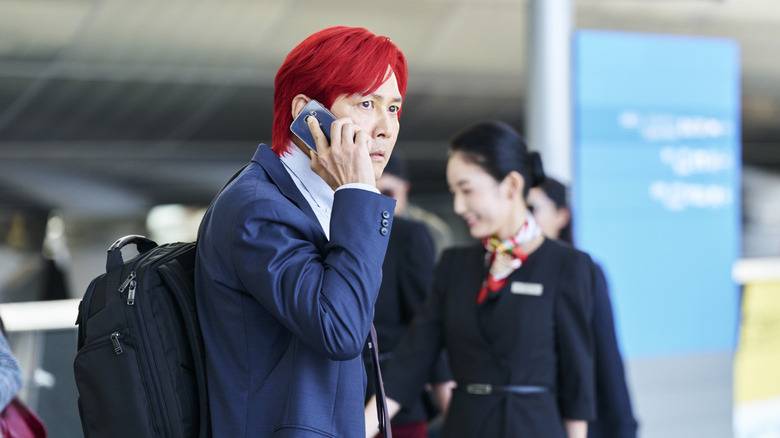 Gi-hun with red hair on the phone in Squid Game