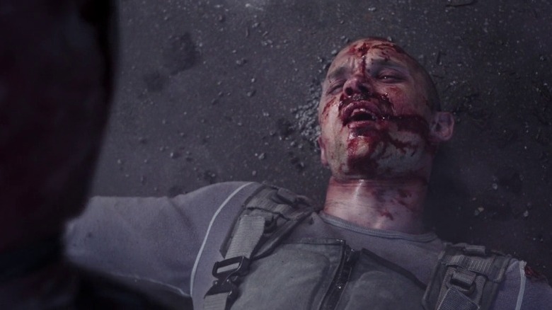 Ajax lying on ground with face bloodied